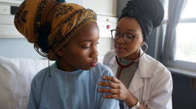 MDR-TB .Young Female Doctor listening with stethoscope on patient's back