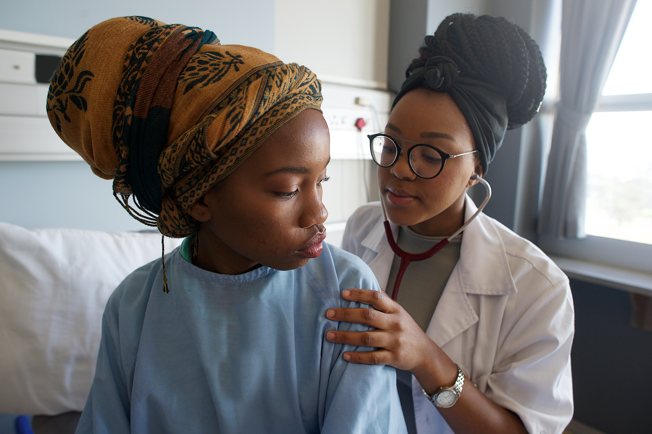 MDR-TB .Young Female Doctor listening with stethoscope on patient's back