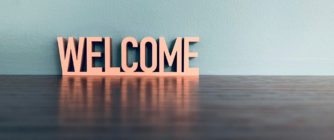 Word welcome on blue background