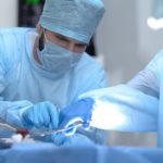 Surgeons implanting central venous catheter