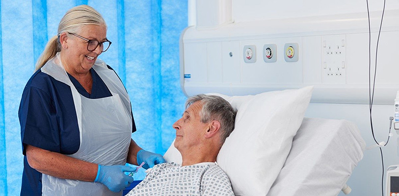 A nurse helping to prevent needlestick injuries and drug contamination.