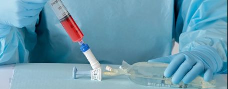 Closed-system transfer device in use to help prevent hazardous drug contamination.