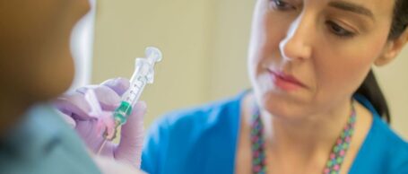 A healthcare worker treating a patient with a device regulated by the EU-MDR.